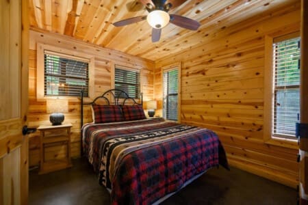 Drift off to sleep in rustic comfort—our cabin bedroom is a cozy haven for relaxation.