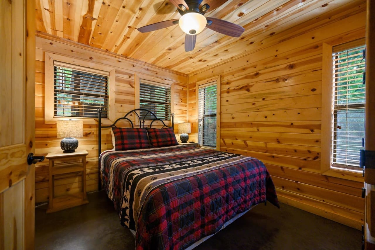 Drift off to sleep in rustic comfort—our cabin bedroom is a cozy haven for relaxation.
