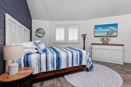 Relax in a bedroom adorned with beachy tones and oceanic elements.