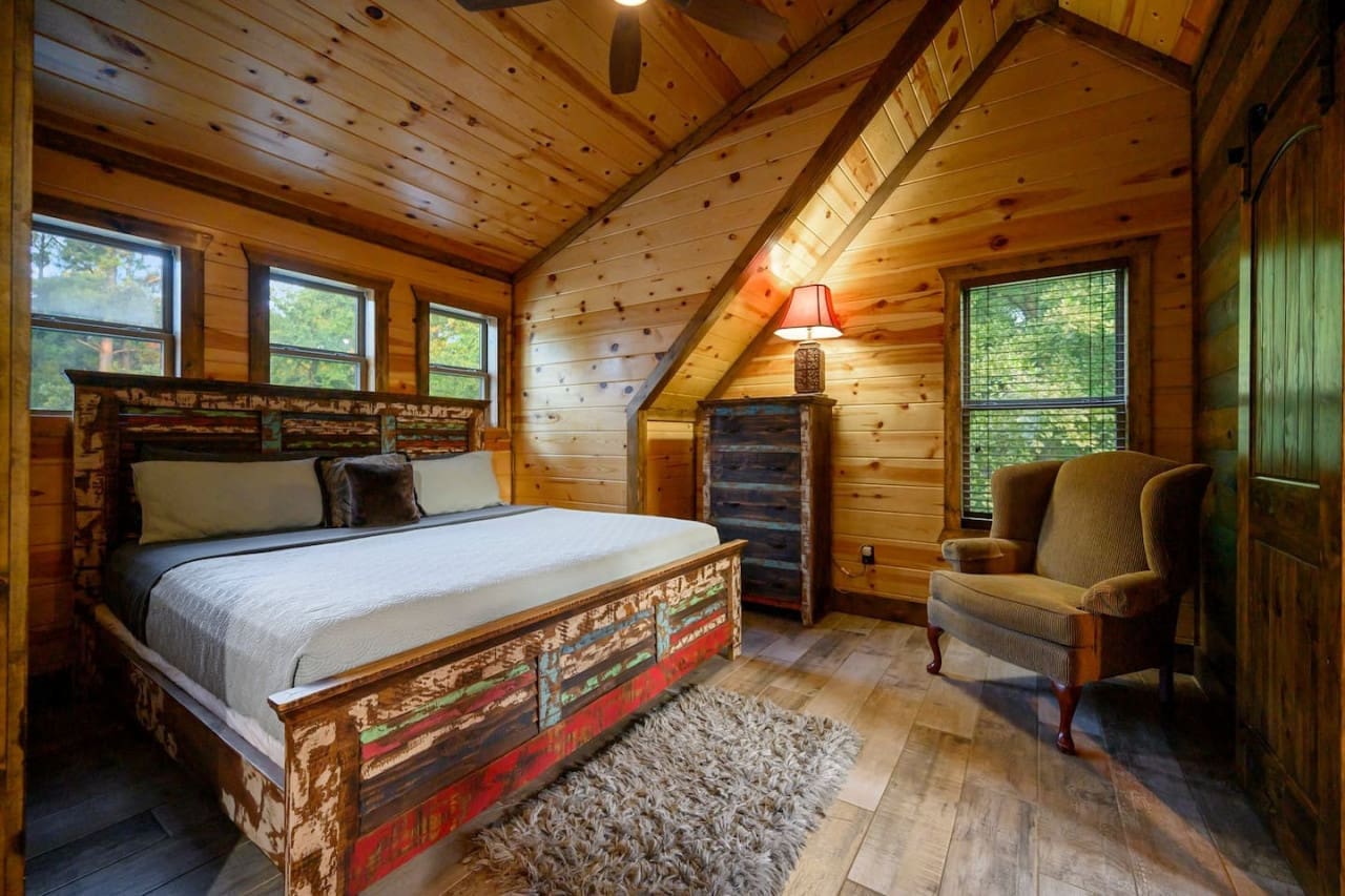 Snuggle up in style—our cozy bedroom with a plush rug and inviting chair is perfect for relaxing and unwinding.