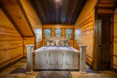 Unwind in style—our cabin’s bedroom offers a peaceful retreat with rustic charm and modern comfort.