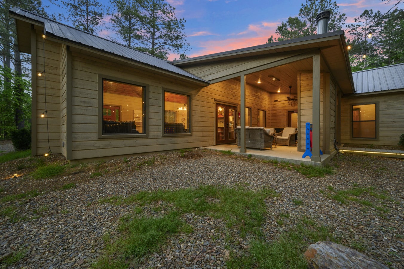 Atmospheric evening shot of the cabin's architecture and back deck area.