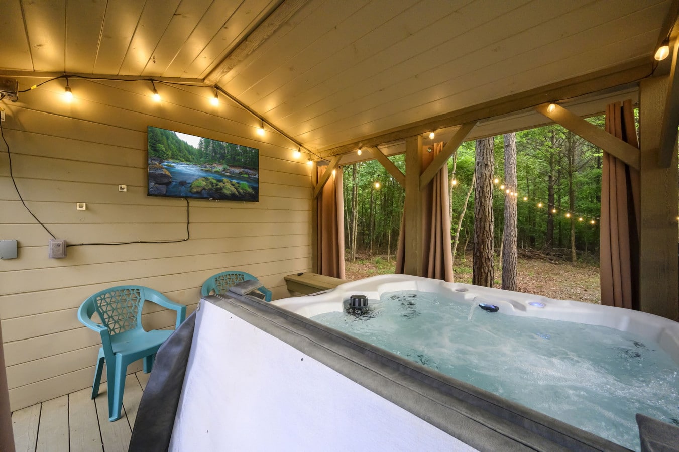 Luxurious hot tub area with an outdoor TV for the ultimate relaxation experience.