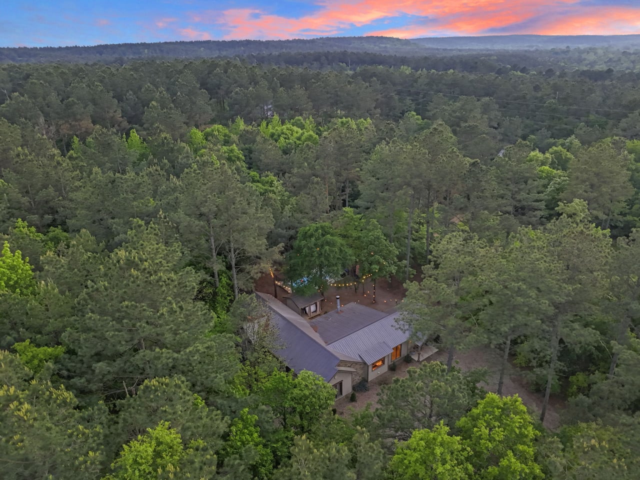 Evening lights cast a warm and welcoming glow over the entire property.