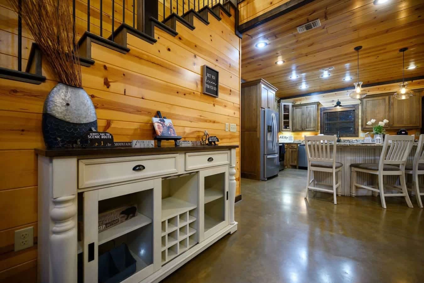 This kitchen island is basically the perfect setup for your crew to hang out while someone's cooking—open shelving, wine storage, and enough barstool seating so nobody feels left out of the action.