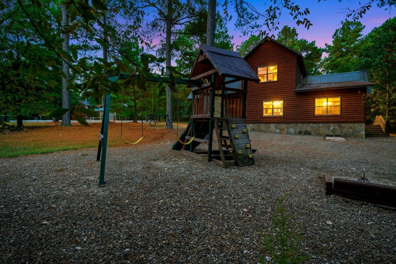 Picture this: dusk falls, the cabin lights up like a beacon in the trees, and you've got swings and a playground right there for the kids to burn off some energy before bedtime.