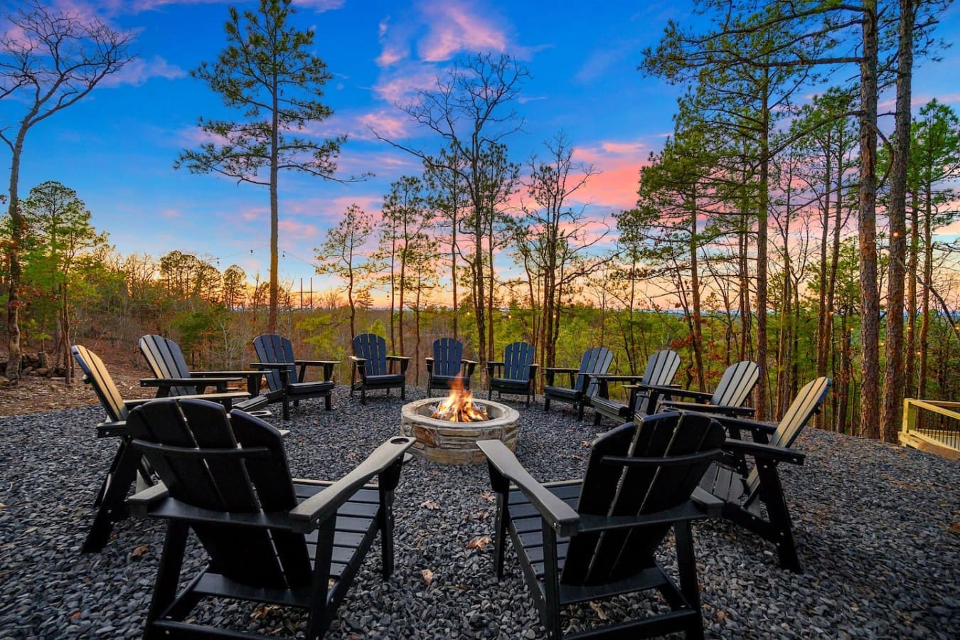 Picture yourself watching the sun paint the sky in pink and orange while sitting around a crackling fire pit surrounded by a sea of black Adirondack chairs and towering pines—it's the kind of spot that makes you never want to leave.