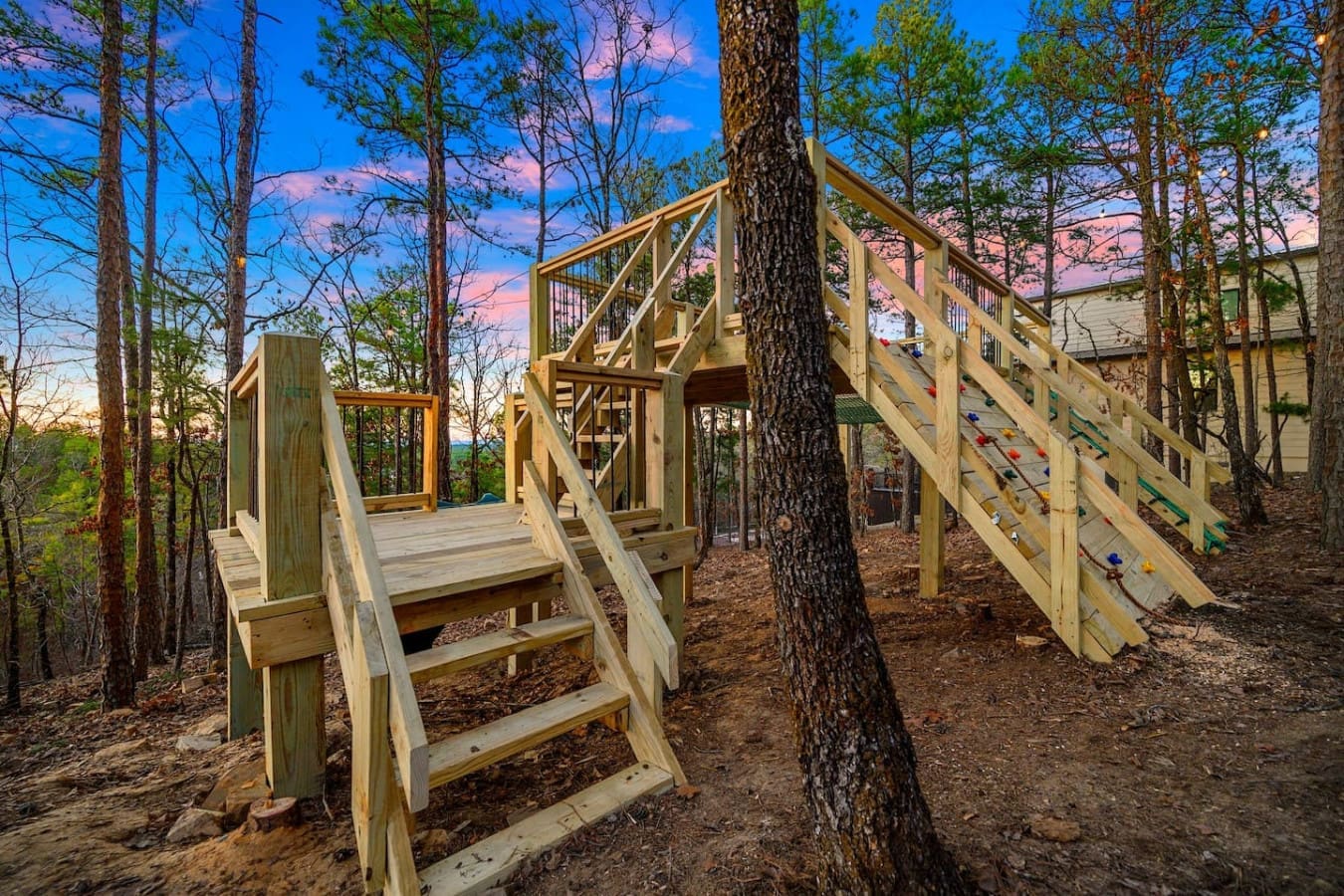 This elevated playground is basically an adventurer's dream with multiple decks, climbing walls, and wooden structures woven right through the trees—perfect for keeping the kids entertained while you soak in those gorgeous forest views.