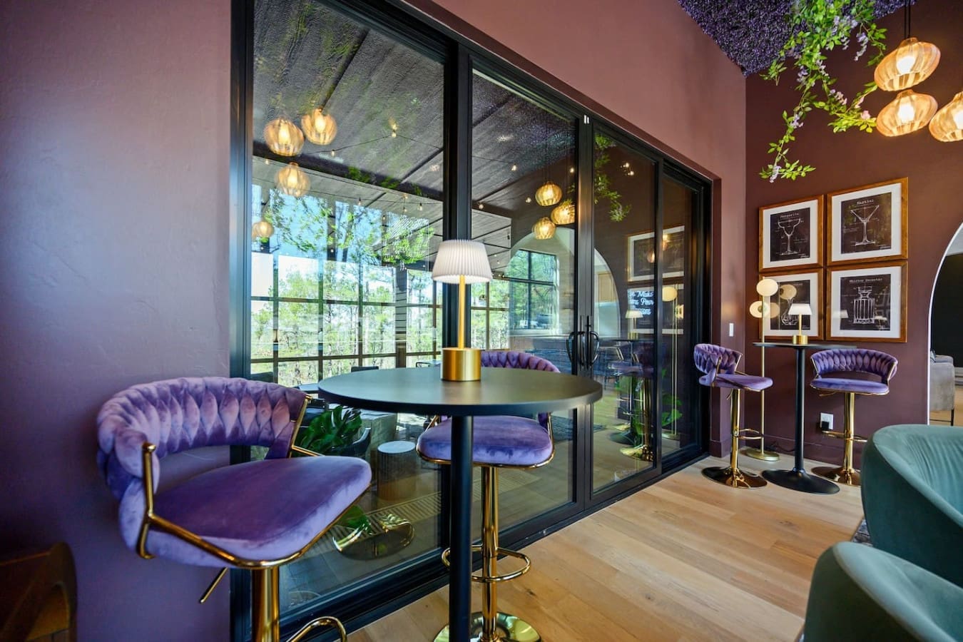 This plush purple lounge with those hanging pendant lights and floor-to-ceiling windows is basically the perfect spot to hang out and chat while the forest views steal the show through the glass.