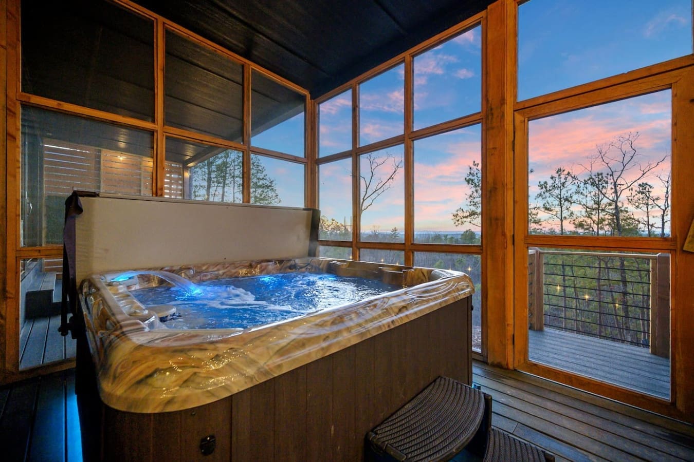 Soaking in a hot tub while watching the sunset paint the sky pink and gold over the forest—honestly, this might be the most perfect end to a day ever.
