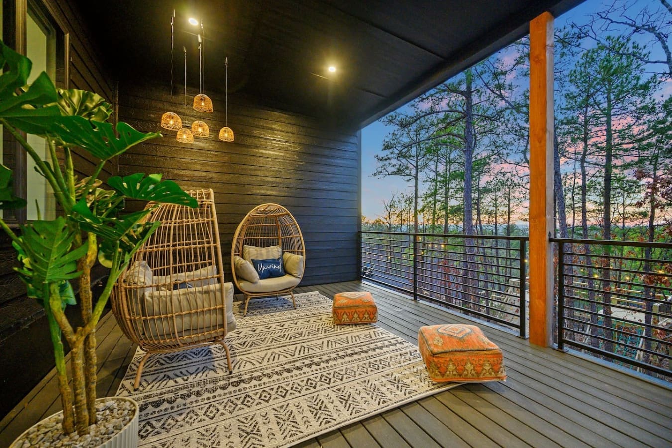 This twilight deck is basically made for those golden-hour moments when you want to kick back in a cozy hanging chair, soak in the forest views, and let those pendant lights set the perfect vibe as the sun dips below the treeline.