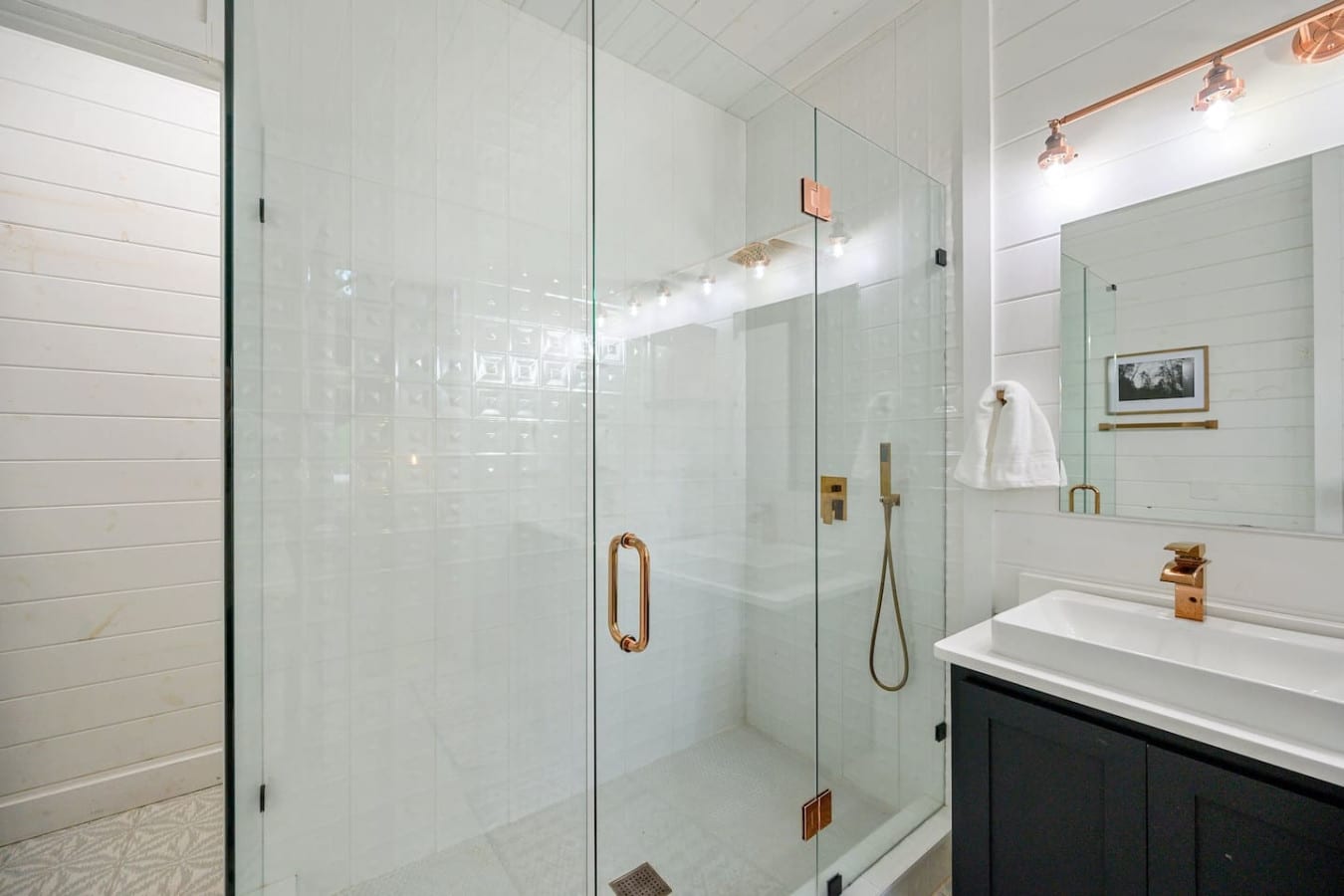 A shower space that shinesu2014crisp lines, warm brass, and spa-day vibes all around.