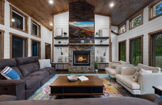 Experience the perfect blend of comfort and charm in our living room, centered around the inviting glow of the fireplace.
