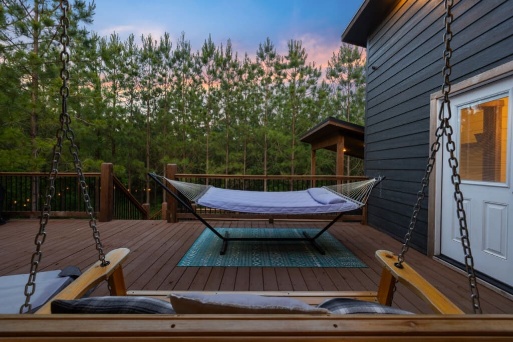 Whether you're curled up with a good book in the hammock or gently rocking in the swing chair, our outdoor sanctuary is your ticket to tranquility.