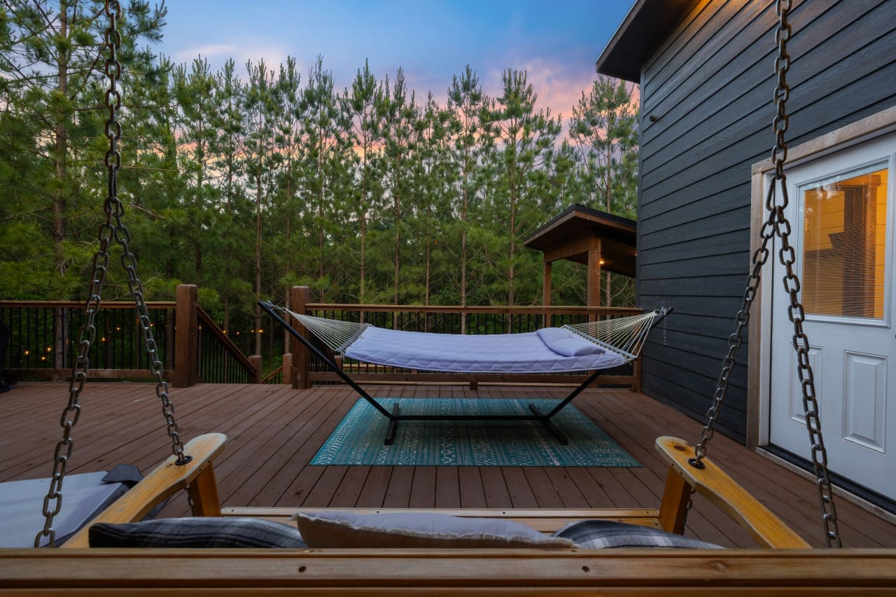 Whether you're curled up with a good book in the hammock or gently rocking in the swing chair, our outdoor sanctuary is your ticket to tranquility.
