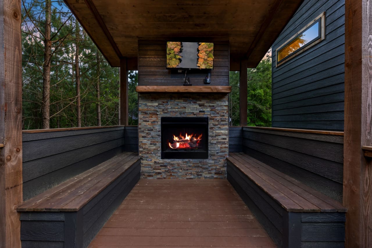 As the flames dance and flicker against the backdrop of natural stone,