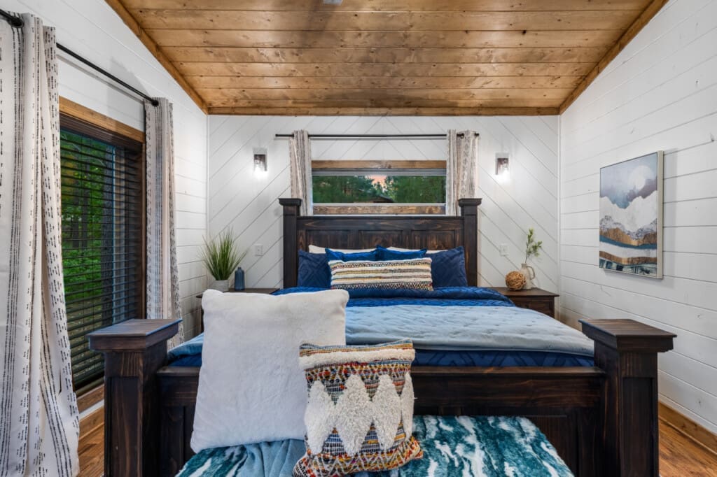 Wake up to the sound of birds chirping and the gentle rustle of leaves in our cozy cabin bedroom.