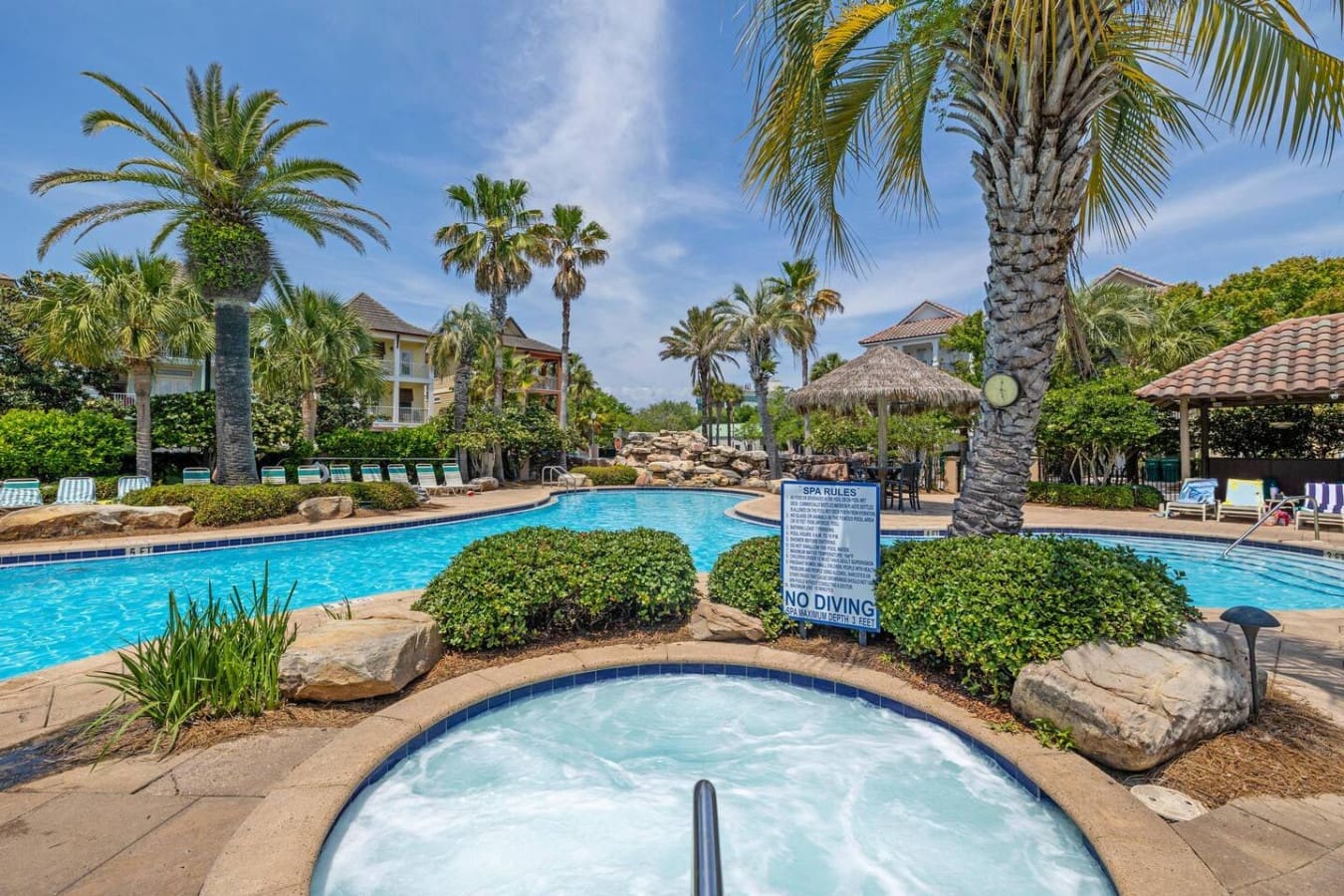Spa day vibes with that hot tub ready to melt away your stress while palm trees sway overhead like they're on vacation too.