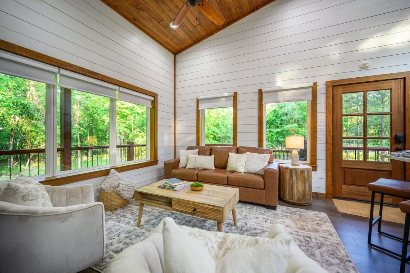 With windows framing the forest from practically every angle, this sunlit living room feels like you're basically hanging out inside the trees themselves.