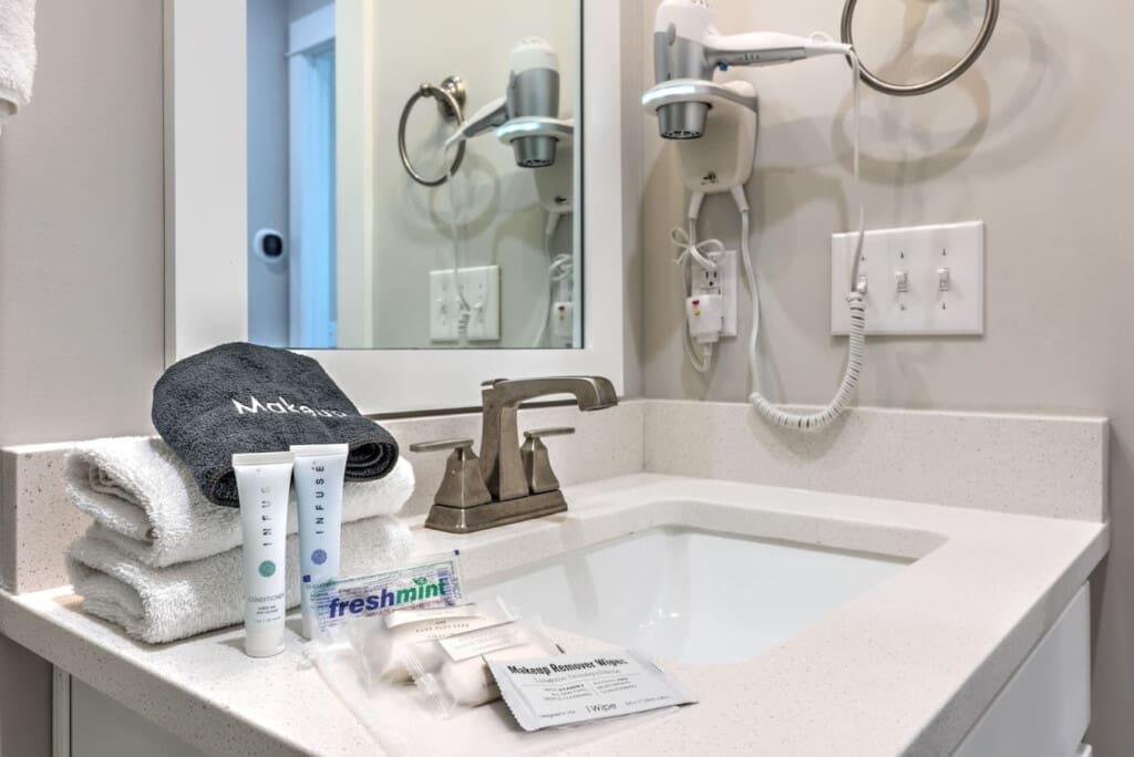 You'll find everything you need to freshen up in this spotless bathroom, complete with modern fixtures, plenty of counter space, and those thoughtful little touches that make a stay feel a little more like home.