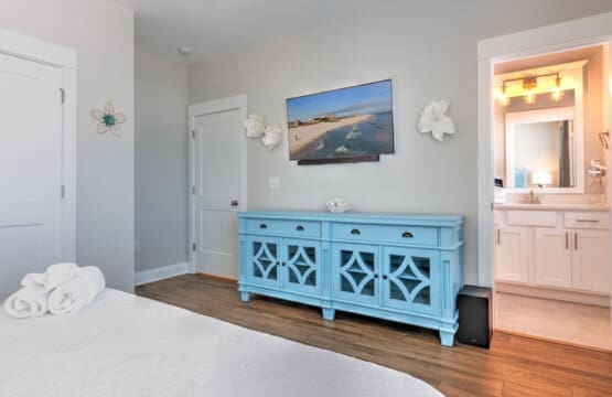 This master suite is basically your own private beach getaway with that gorgeous blue cabinet as a statement piece, a flat-screen to catch the views, and an ensuite bathroom that's all yours to enjoy.