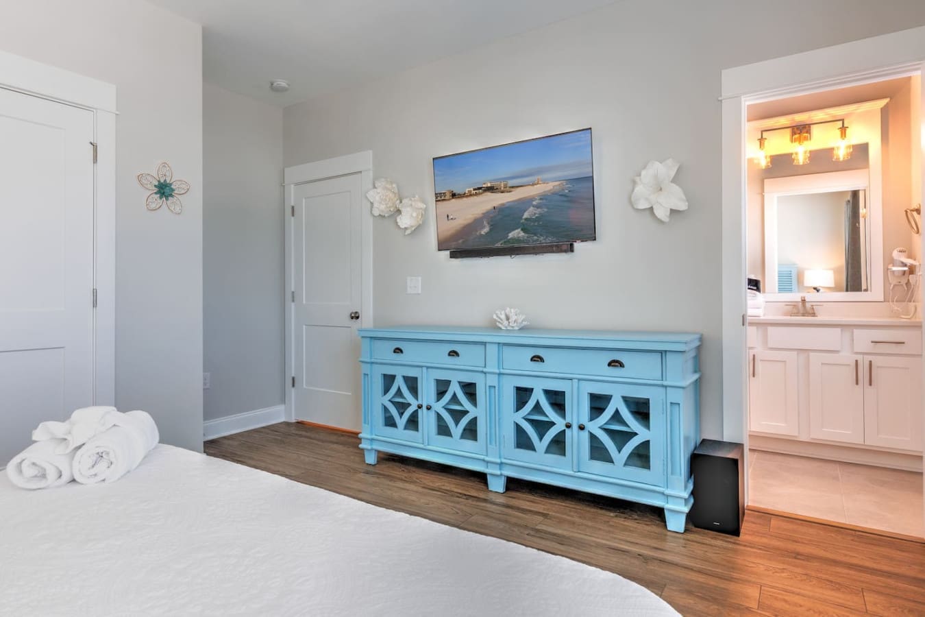 This master suite is basically your own private beach getaway with that gorgeous blue cabinet as a statement piece, a flat-screen to catch the views, and an ensuite bathroom that's all yours to enjoy.