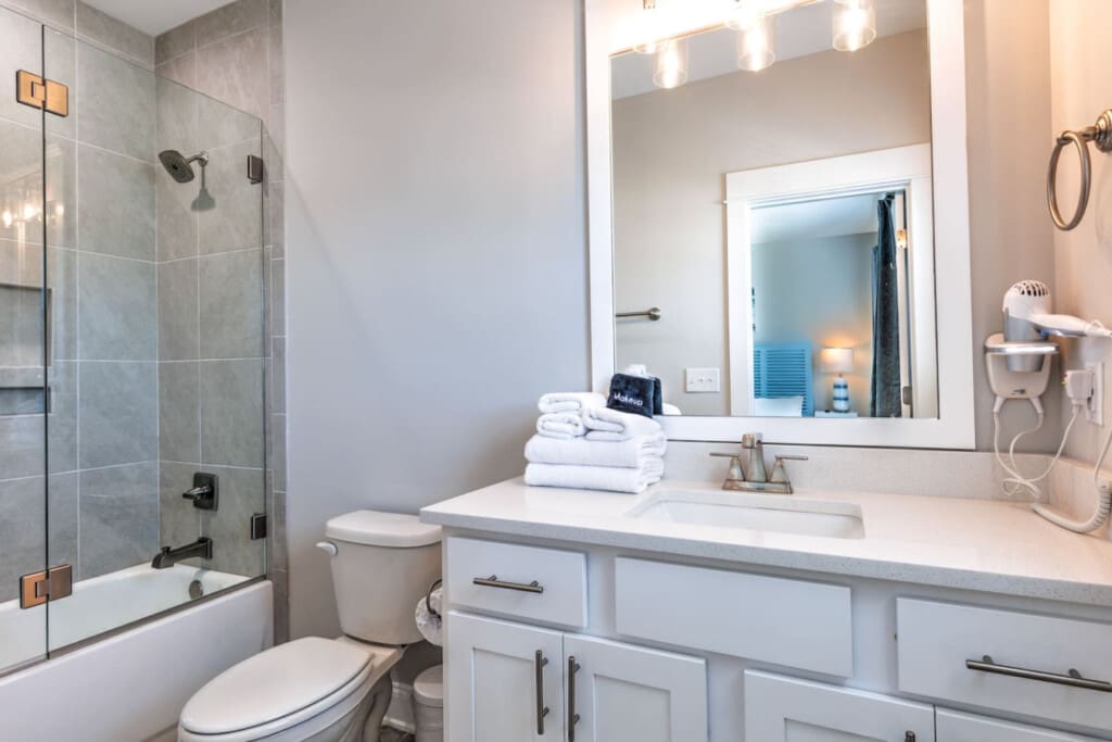 This bathroom is seriously the whole package—clean lines, a huge vanity with plenty of counter space, that gorgeous walk-in shower, and honestly just enough light and polish to make your morning routine feel way less painful.