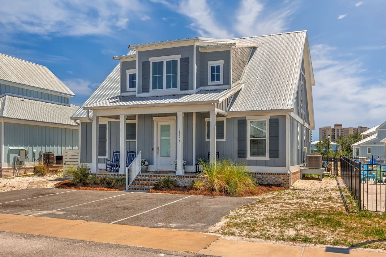 This charming modern farmhouse is basically your ticket to a laid-back beach getaway where you can lounge on the porch, watch the sunset, and feel like you're living in a design magazine.