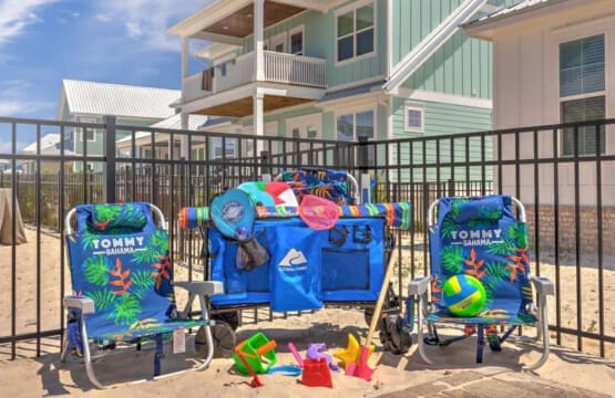 Your kids will be happily occupied all day with this epic beach setup—complete with a bounce house, toys, and chairs right there in the sand.