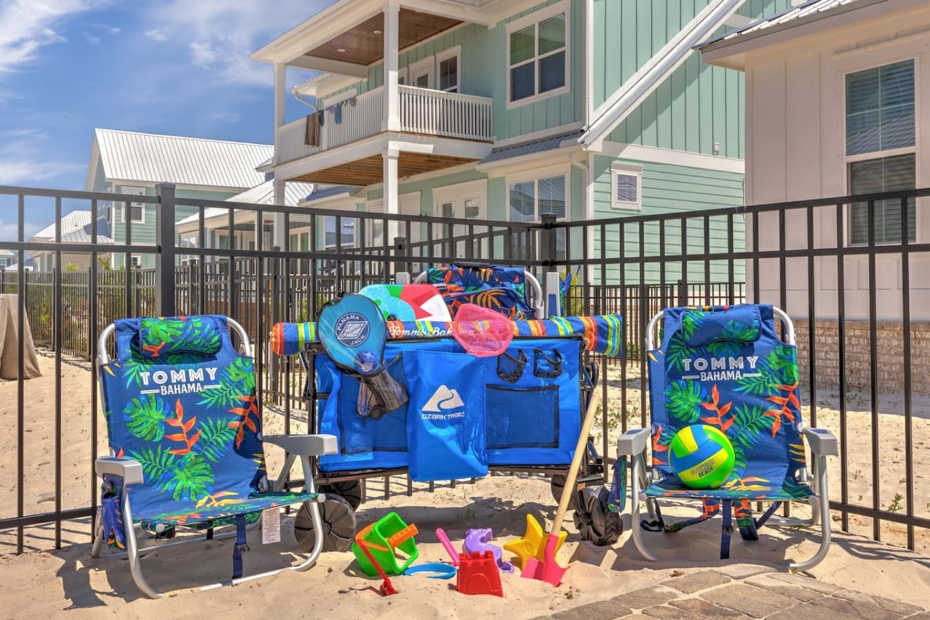 Your kids will be happily occupied all day with this epic beach setup—complete with a bounce house, toys, and chairs right there in the sand.