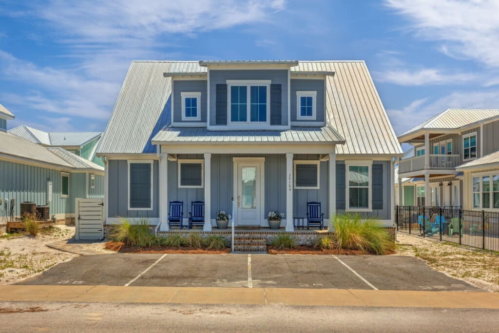 This modern farmhouse is giving major coastal charm with that crisp blue-and-white color combo and those inviting porches just begging you to kick back and watch the world go by.