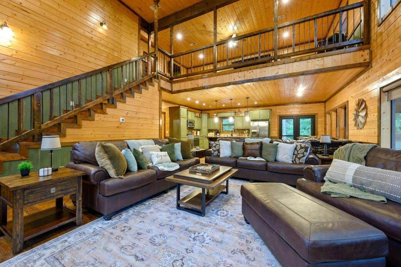 This main living room is basically what happens when you build a house that's all windows and wood beams and then fill it with enough seating for everyone to actually get comfortable at the same time.