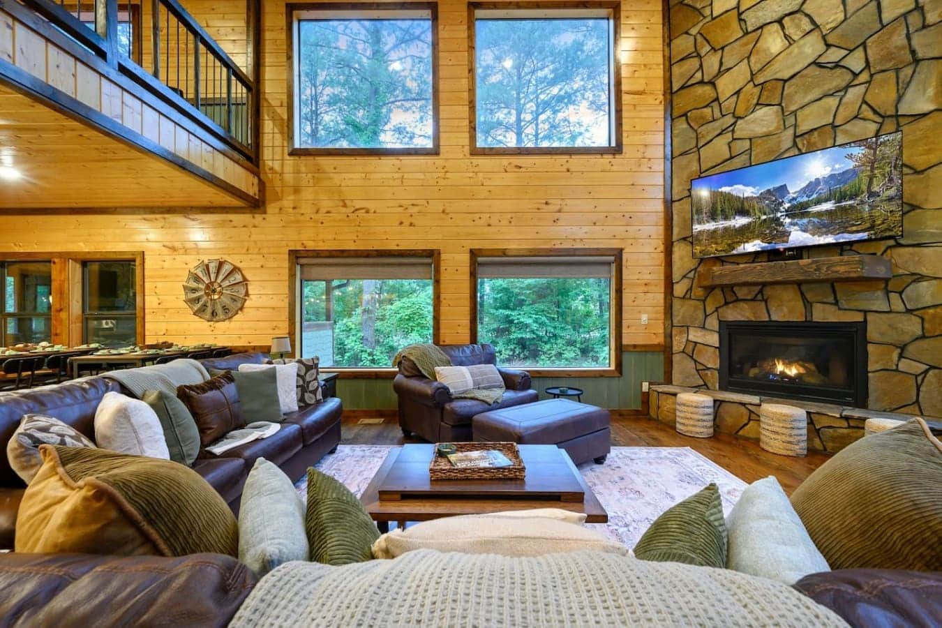 This is the kind of living room where you'd genuinely lose hours just hanging out by the fire with a view of the trees out every window.