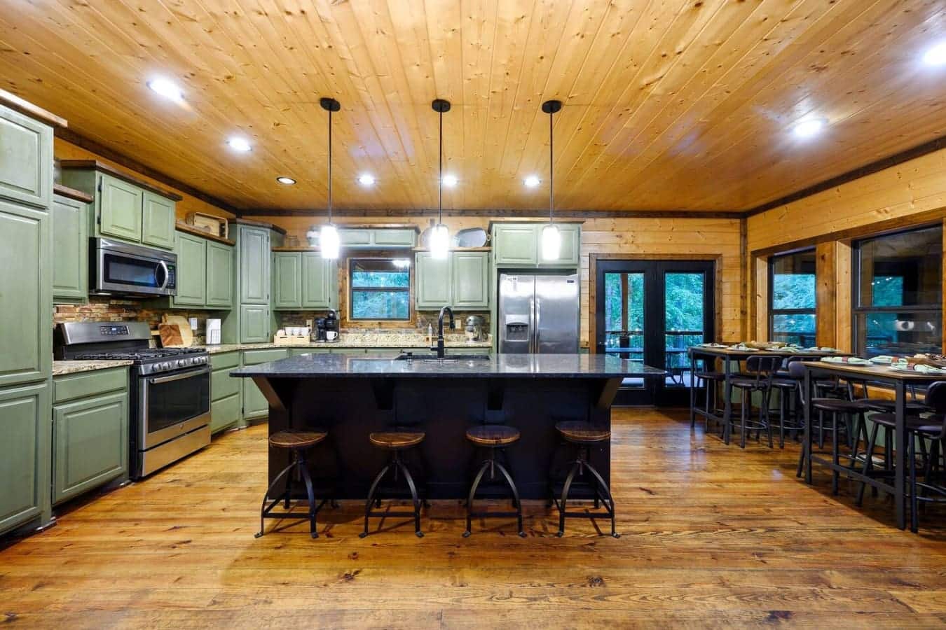 This kitchen-to-dining setup is basically made for feeding a crowd without anyone feeling like they're stuck doing dishes while the party happens somewhere else.