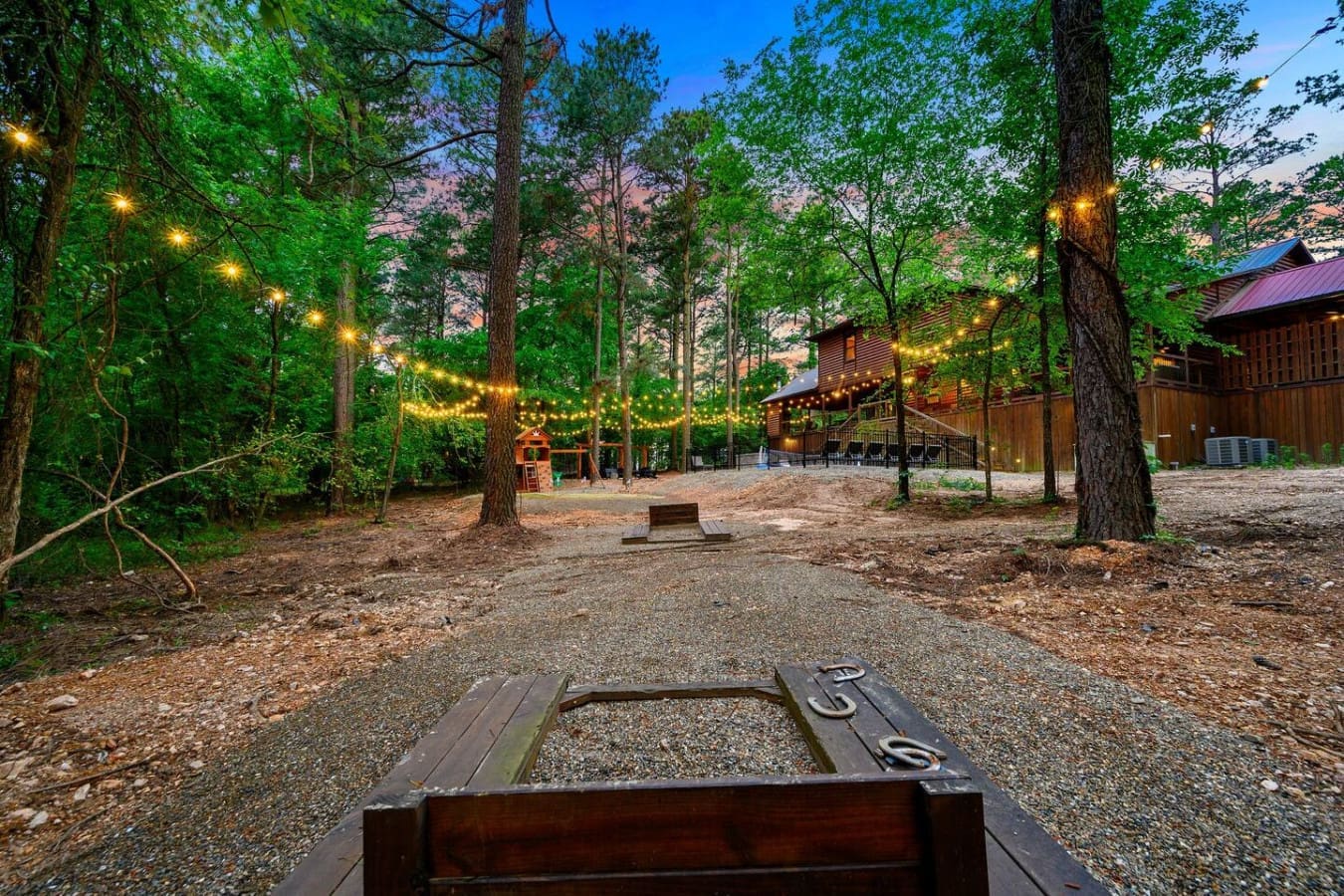 You've got cornhole, string lights strung between the trees, a fire pit waiting to be lit, and enough space for your whole crew to spread out—this is basically what backyard hangouts were invented for.