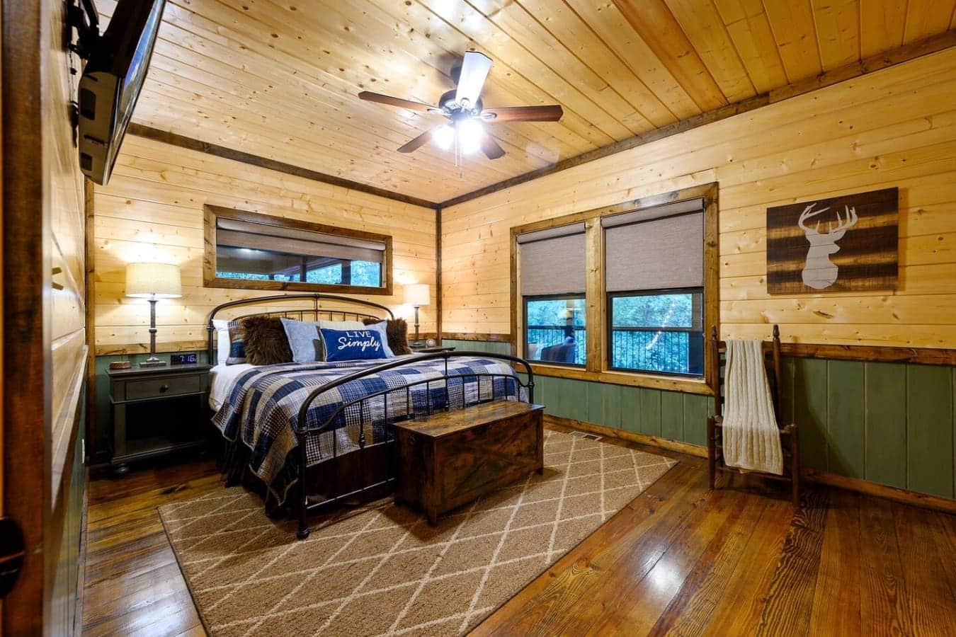 Wake up in this wood-paneled bedroom and you'll immediately get why people lose track of time at places like this—it's cozy without feeling cramped, and those big windows mean the forest views are basically your alarm clock.
