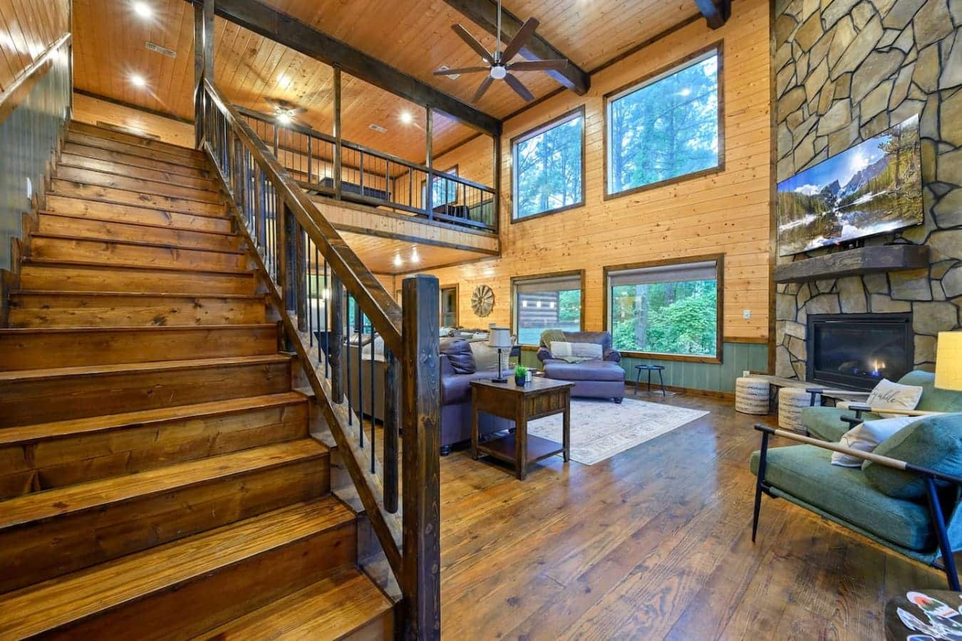 This lofted living room gives you that "we rented a cabin and actually never want to leave" energy with the soaring wood ceilings, natural light pouring in from everywhere, and a layout where everyone can chill without being on top of each other.