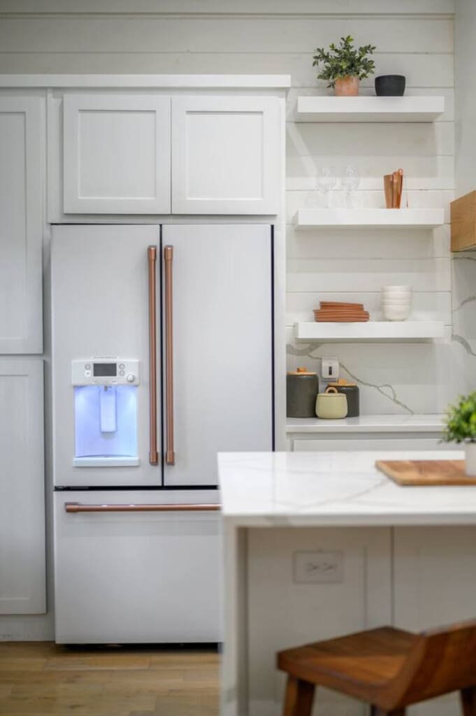 Minimalist shelving, earthy accents, and a fridge that fits right in.