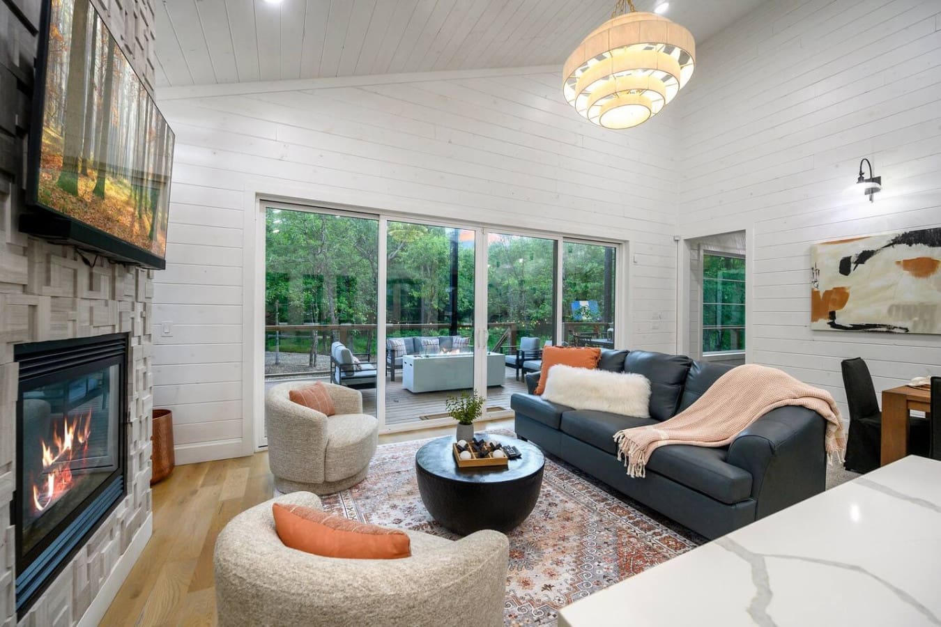 Wake up with the trees, wind down by the fire—this living room was made for slow moments and scenic views.