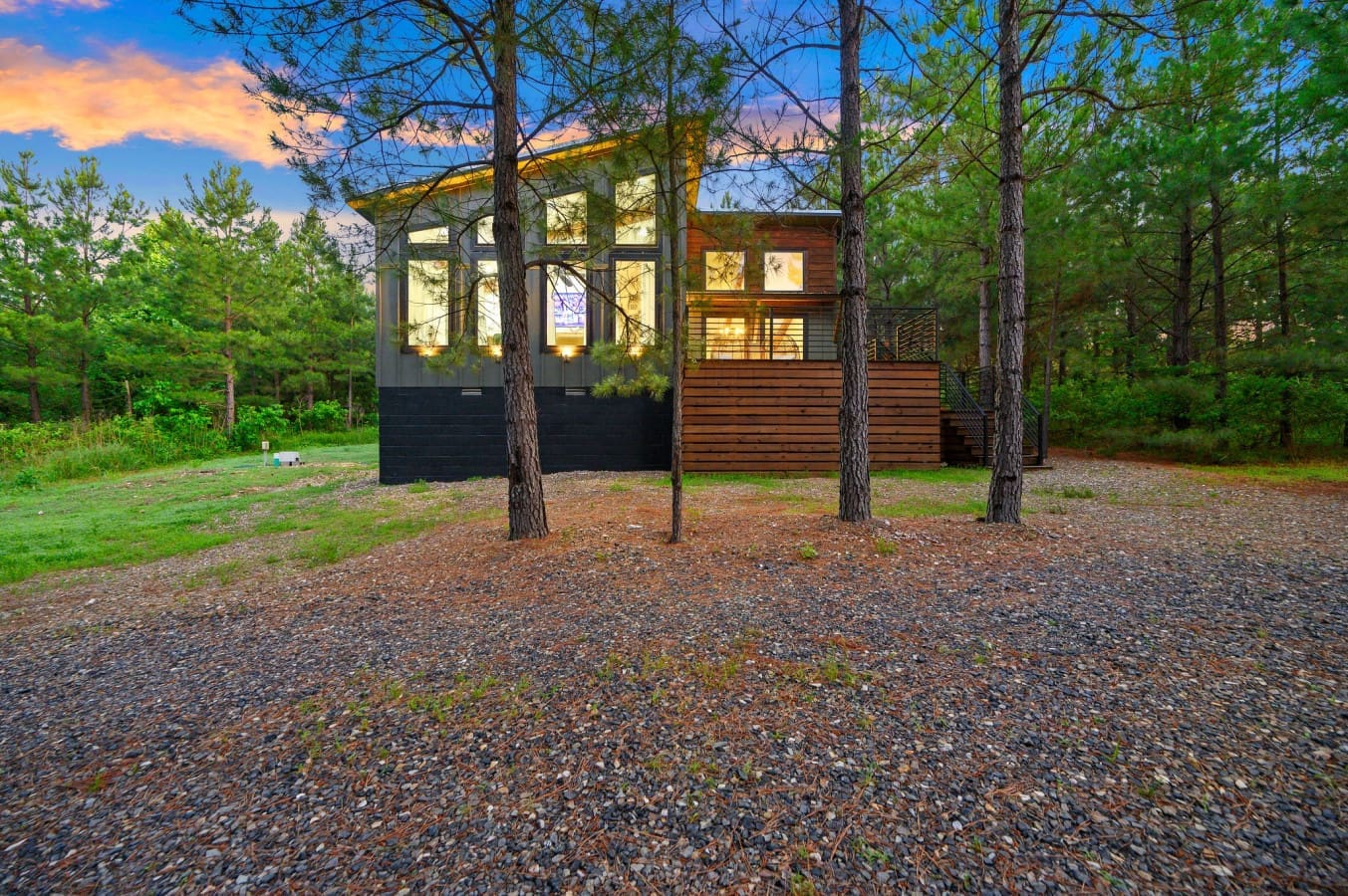 Tucked among the pines, this modern retreat glows with warmth and style