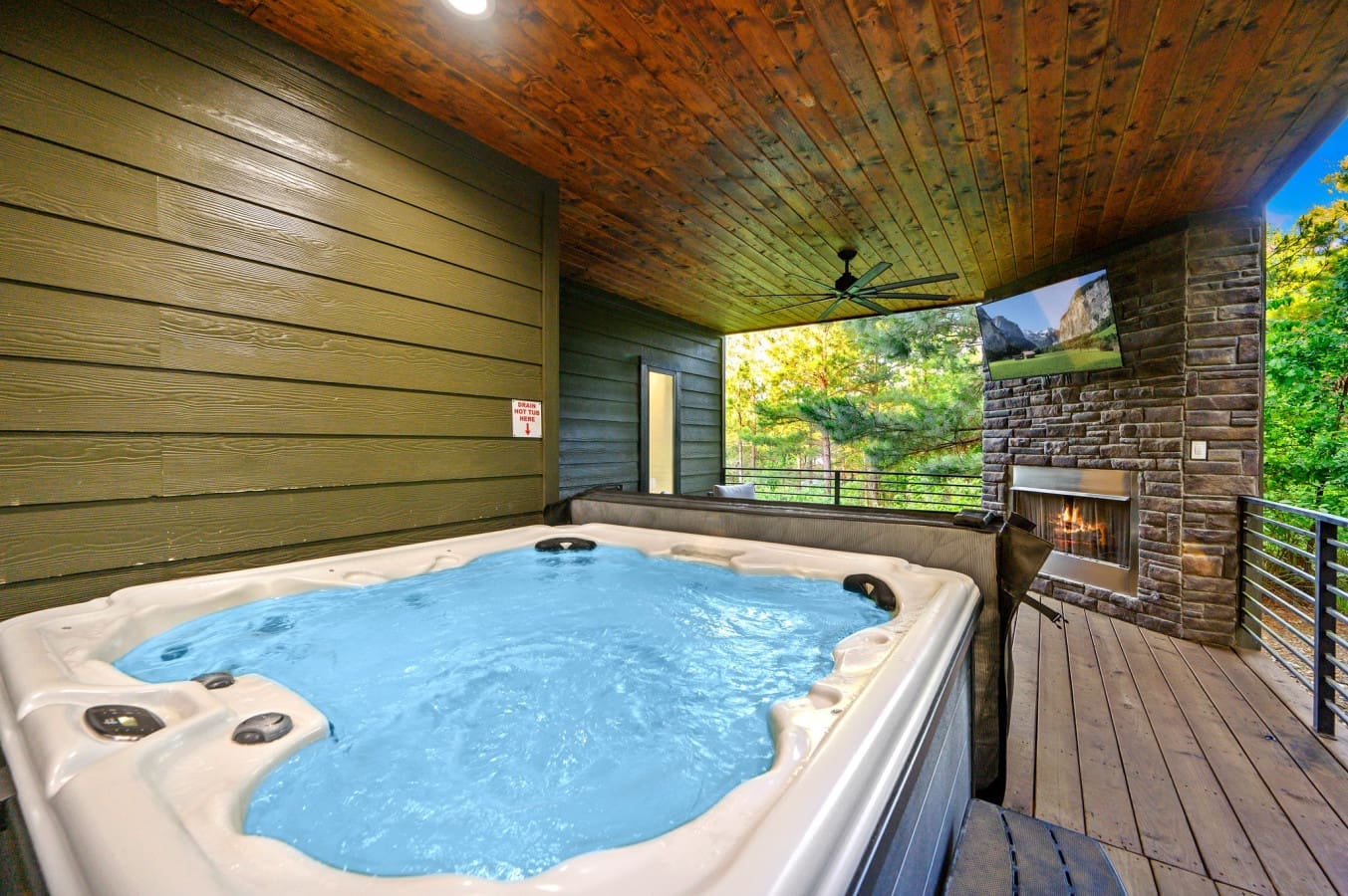 Hot tub bliss meets forest views and fireplace glow.