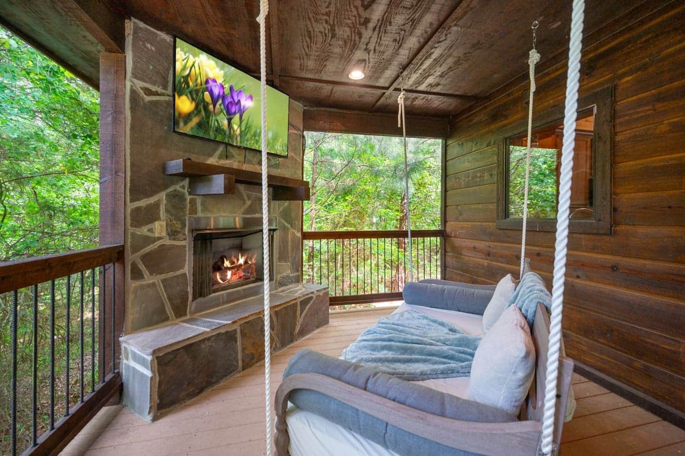 Swing into relaxation beside the outdoor fireplace and mounted TV.