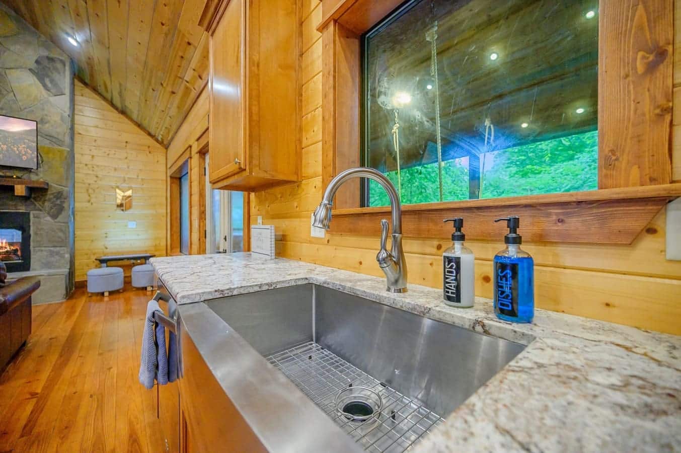 Modern kitchen sink with window view and space to prep.