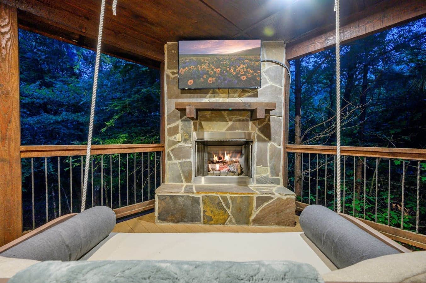 Snuggle by the outdoor fireplace with TV entertainment and swing seating.