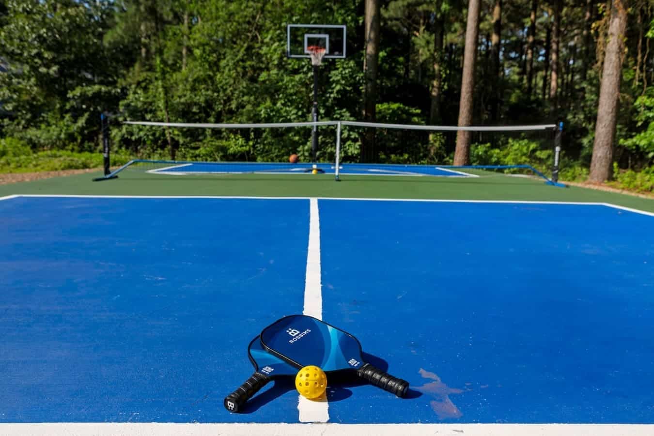 Game, set, match! 🎾🏀 A perfect court for pickleball and hoops in the heart of nature.