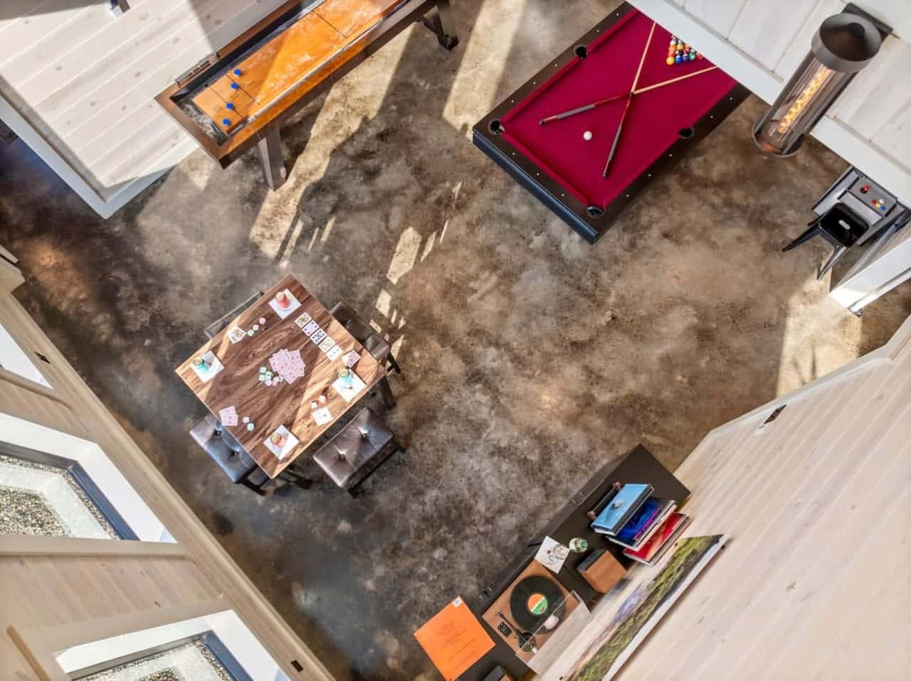 Ultimate game room vibes: cards, pool, shuffleboard, and vinyl.
