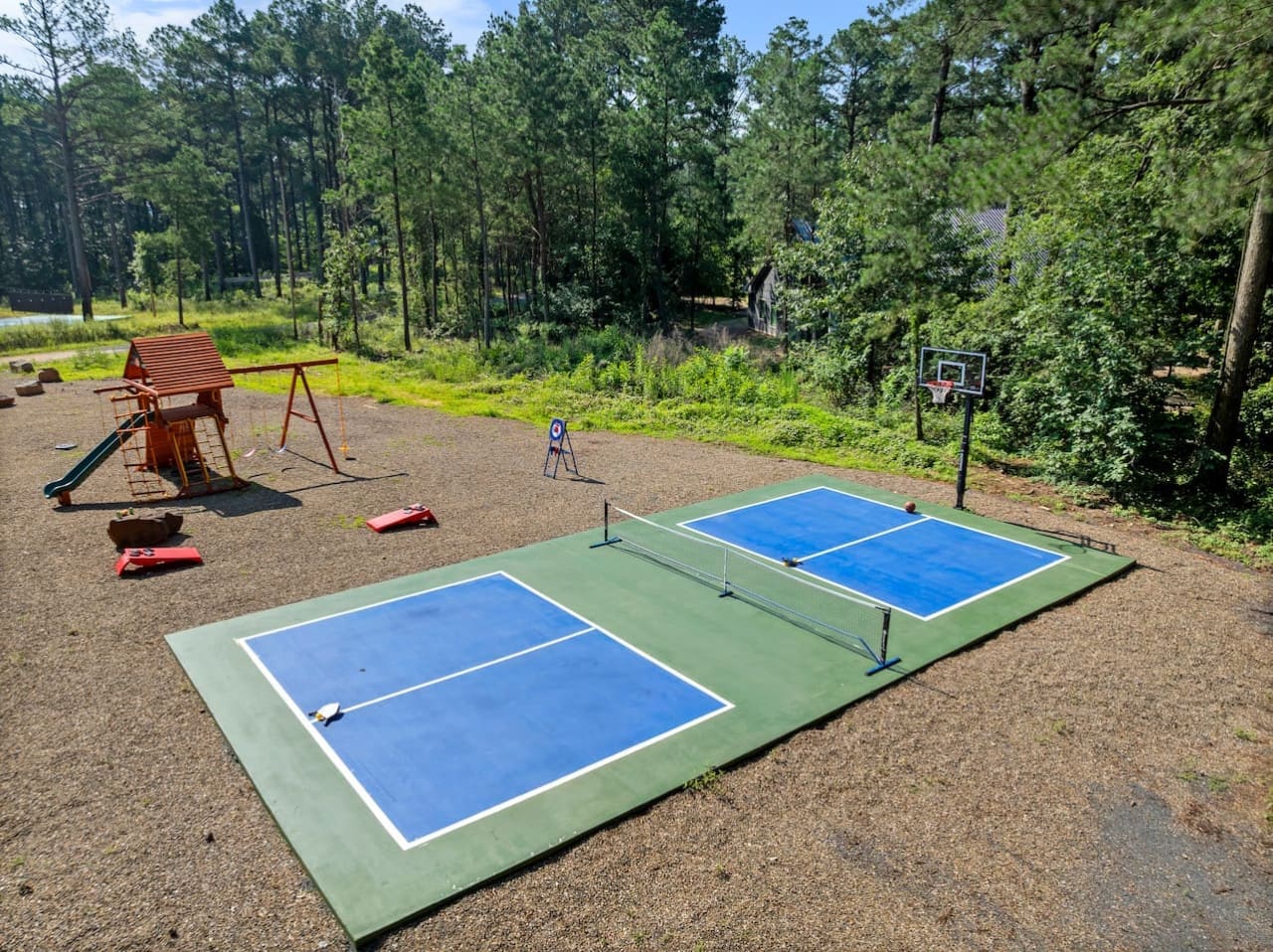 Endless outdoor fun awaits with a private sports court, basketball hoop, playground, and yard games for all ages to enjoy!