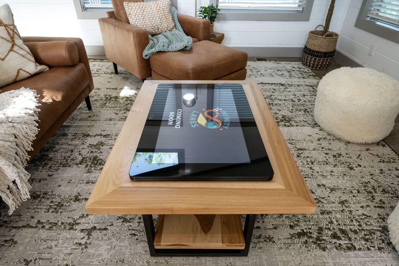 This living room's got that cool interactive coffee table that'll have everyone gathered around like it's the main event.