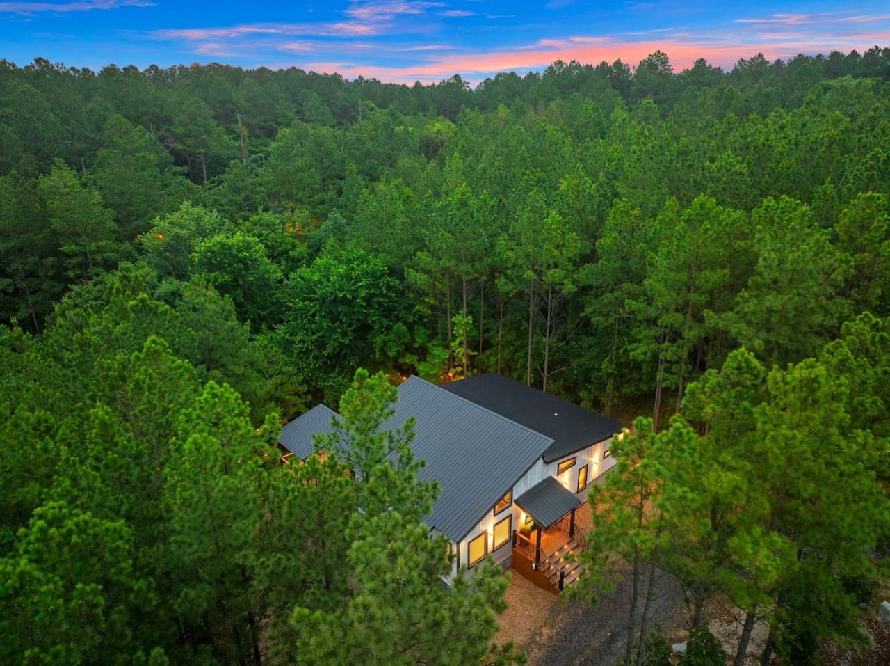 This sleek modern hideaway is basically nature's version of a cozy hug, surrounded by all those tall trees that make you forget the outside world even exists.