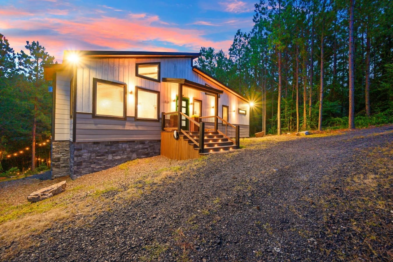 This sleek little hideaway tucked into the woods at twilight is basically your permission slip to disappear from the world for a few days.